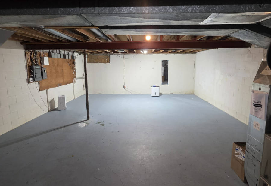 The same basement floor clean and sanitized after light surface-mould cleaning